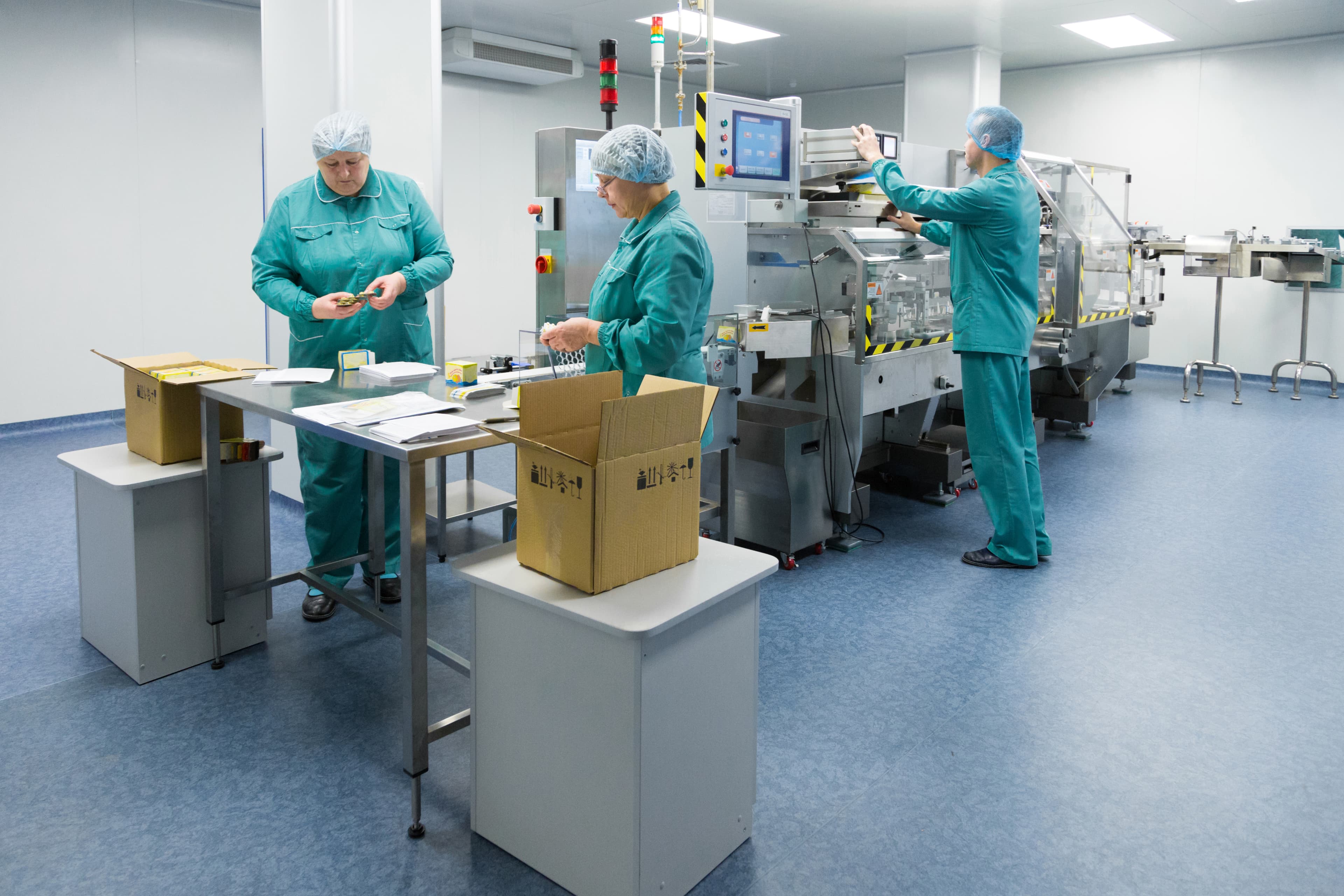 Quality control team inspecting packaging in a cleanroom